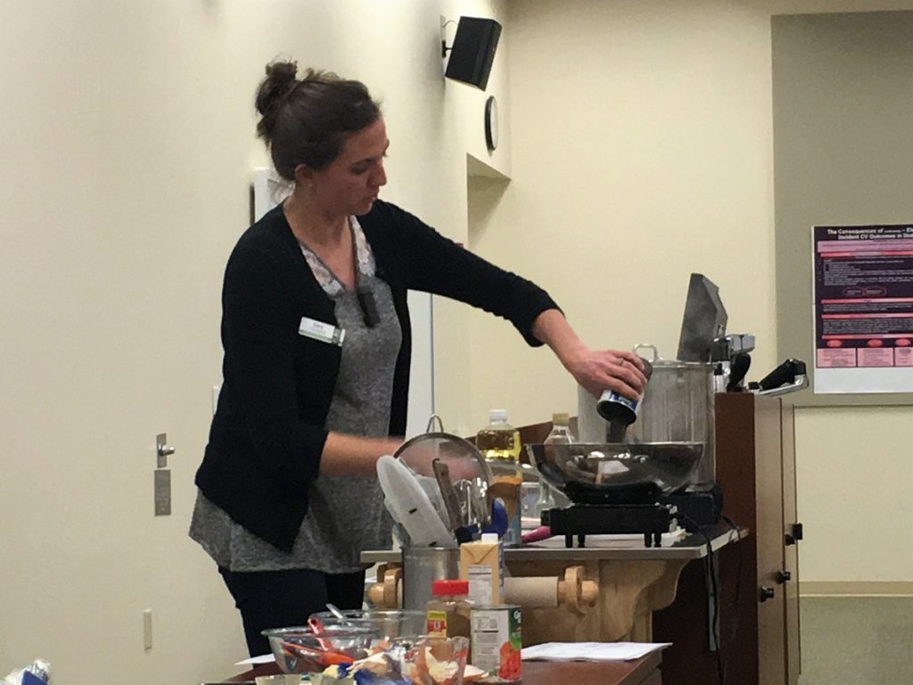 Nutrition Director Sara cooks at a small demo kitchen
