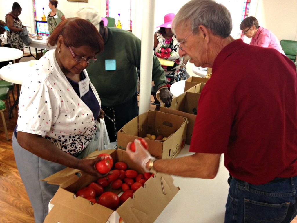 Senior picking out produce at a food pantry