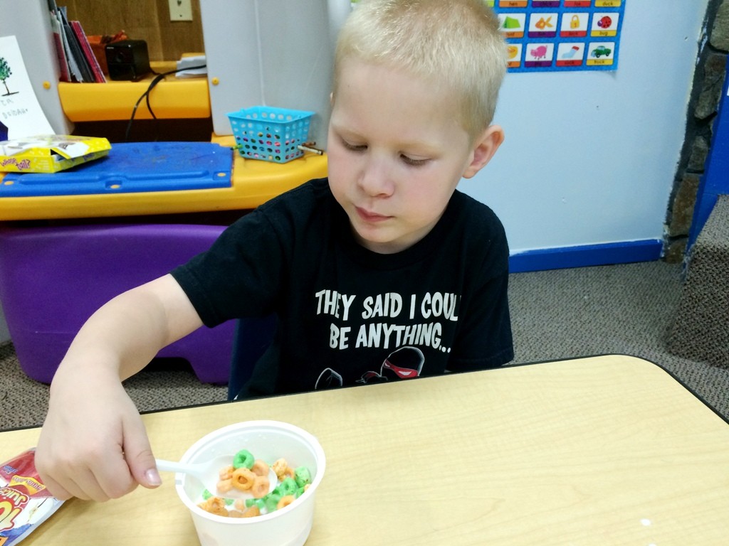 Photo of a boy eating cereal at a Kids Summer Meals site