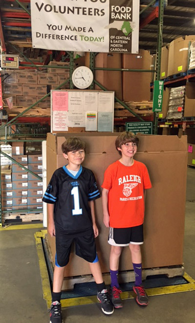 Case (right) and Harry (left) proudly weigh the food donations from their combined birthday food drive