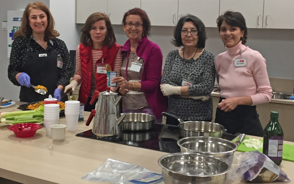 American Turkish Association volunteers prepare healthy dishes in the Food Bank's Allscripts Teaching Kitchen
