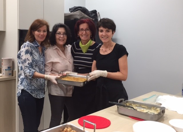 American Turkish Association volunteers cook together in the Allscripts Teaching Kitchen