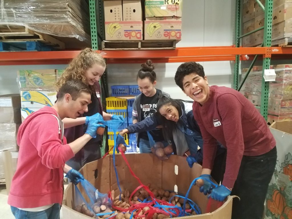 Franklin Academy volunteers sorting potatoes