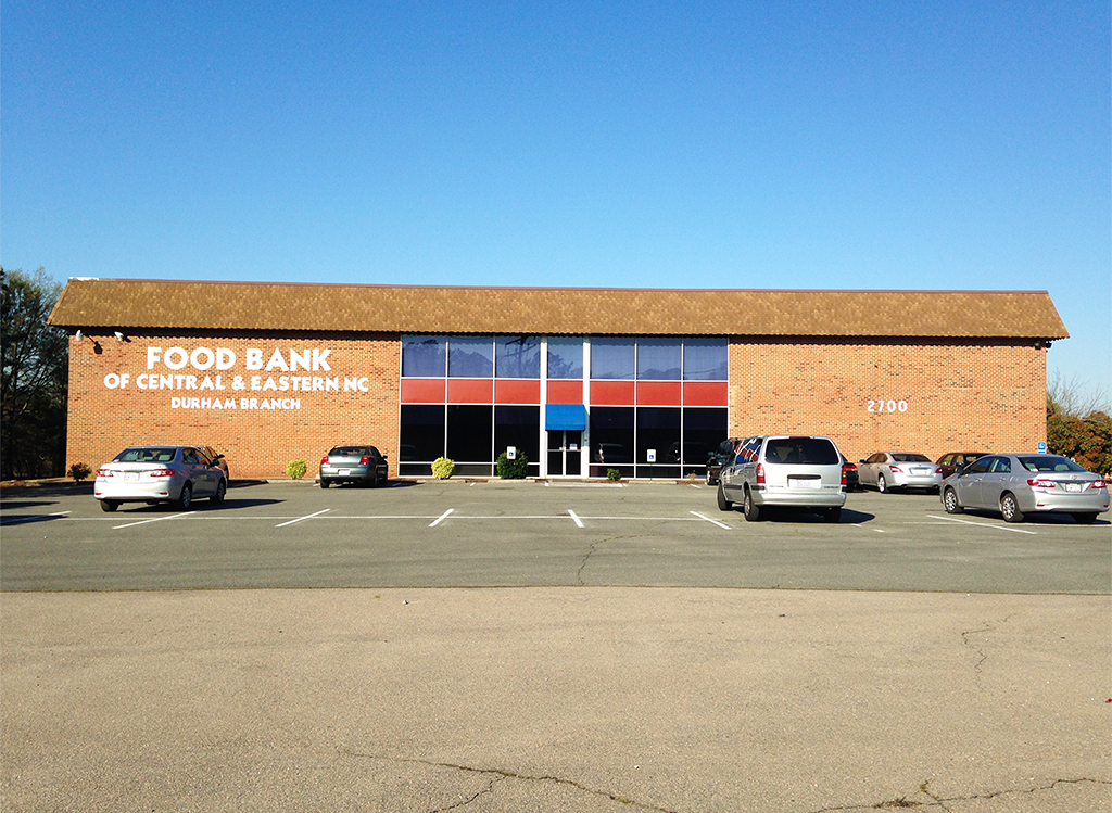 Exterior of Durham Branch. Red brick building with white letters reading Food Bank of Central & Eastern NC