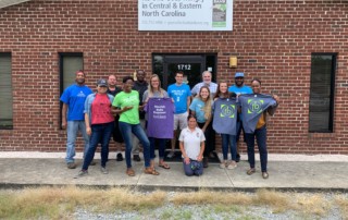 Group of 15 Greenville & New Bern branch staff members gather in food bank t-shirts