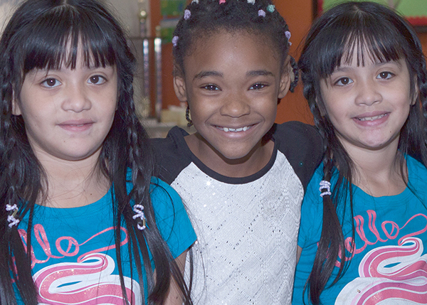 3 girls smiling at a Kids Cafe 