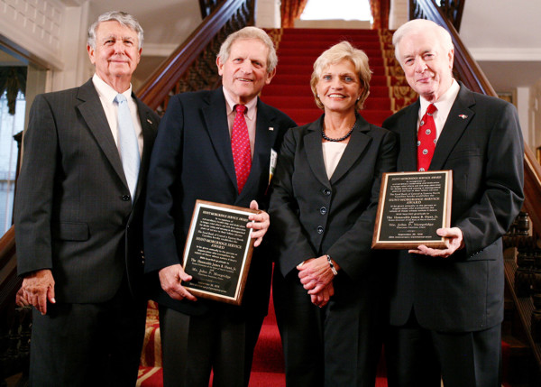 Governor James Hunt and John P Mordridge with smiling with plaques surrounded by 2 others