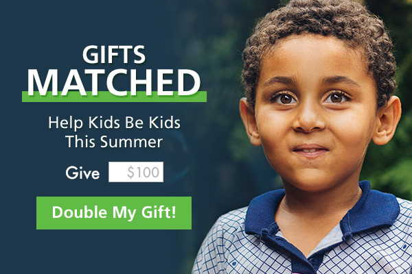 Little boy smiles next to words, "Gifts Matched Help Kids be Kids" Give $100 - Double My Gift" 