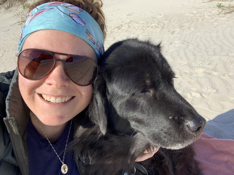 Kathleen Hoolihan and her dog at the beach